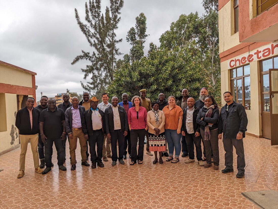 Researchers, county officers and a ranger outside a meeting venue in Narok